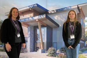 Sheri and Marlee Shanahan stand  in front of a rendering of Jesse's House, named in honour of Sheri's late daughter. The 16-bedroom home away from home will welcome families whose children are receiving medical care in the Nanaimo area.